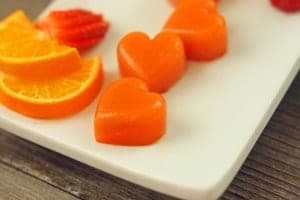 Homemade pink and orange fruit gelatin chews in playful shapes